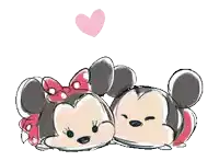 mickey mouse and minnie mouse are laying next to each other with a pink heart above them .