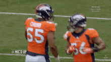 two denver broncos football players number 55 and 56 are hugging each other