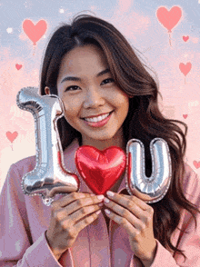 a woman holding balloons that say i love you and a red heart