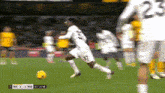 a soccer player wearing number 23 runs toward the ball