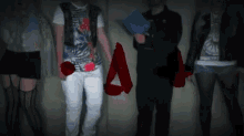 a group of people are standing next to each other in a dark room and one of them is wearing a hat