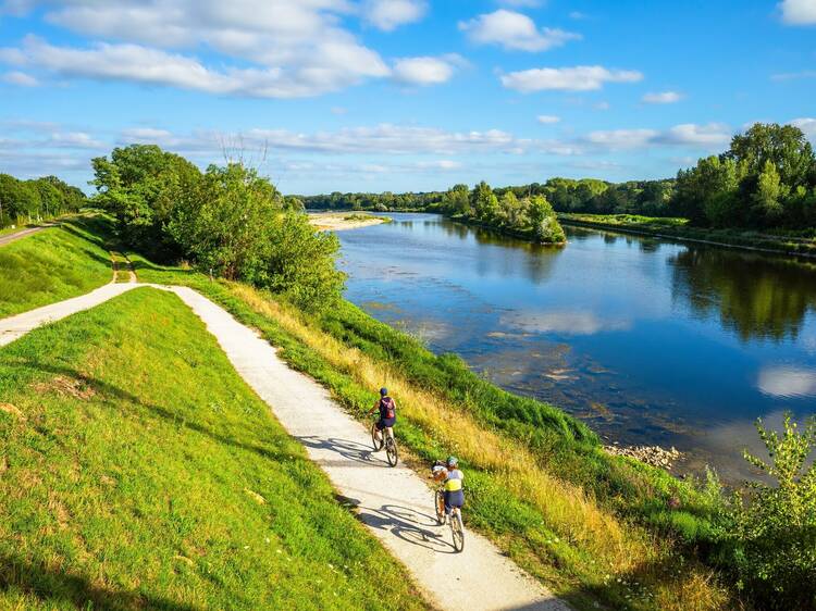 Chatilllon sur Loire, France - August 9, 2023: Cyclists ride on thefra cycle path along the Loire River in France.