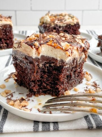 piece of chocolate caramel poke cake on white plate