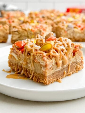 A Nutter Butter bar drizzled with peanut butter on a white plate.