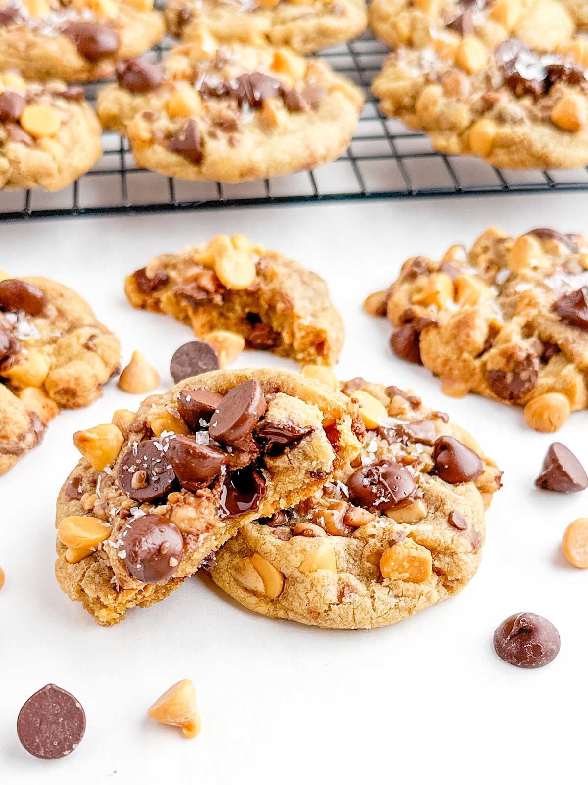 half of a butterscotch chocolate chip cookie resting on a full cookie.