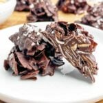 dark chocolate coconut haystacks on a white plate.