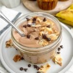 coffee yogurt topped with coconut, almonds, and chocolate chips in a mason jar.