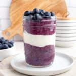 berry chia seed pudding layered with yogurt in a mason jar.