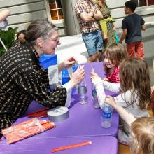 Docent working with children on crafts