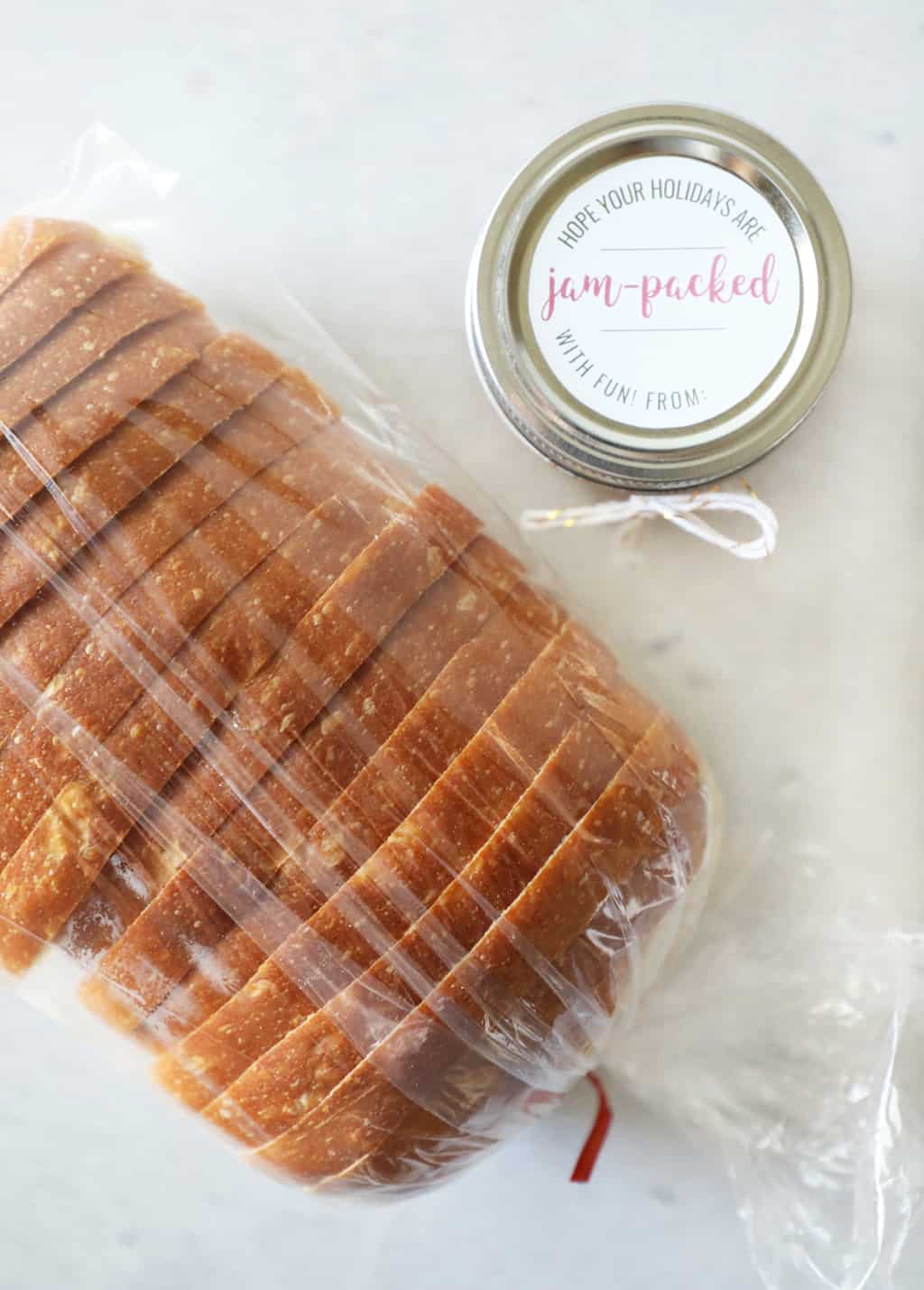 birds eye view of a loaf of sliced bread and small jar of jam