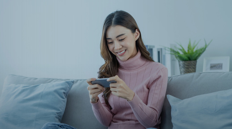 Woman playing mobile game at home