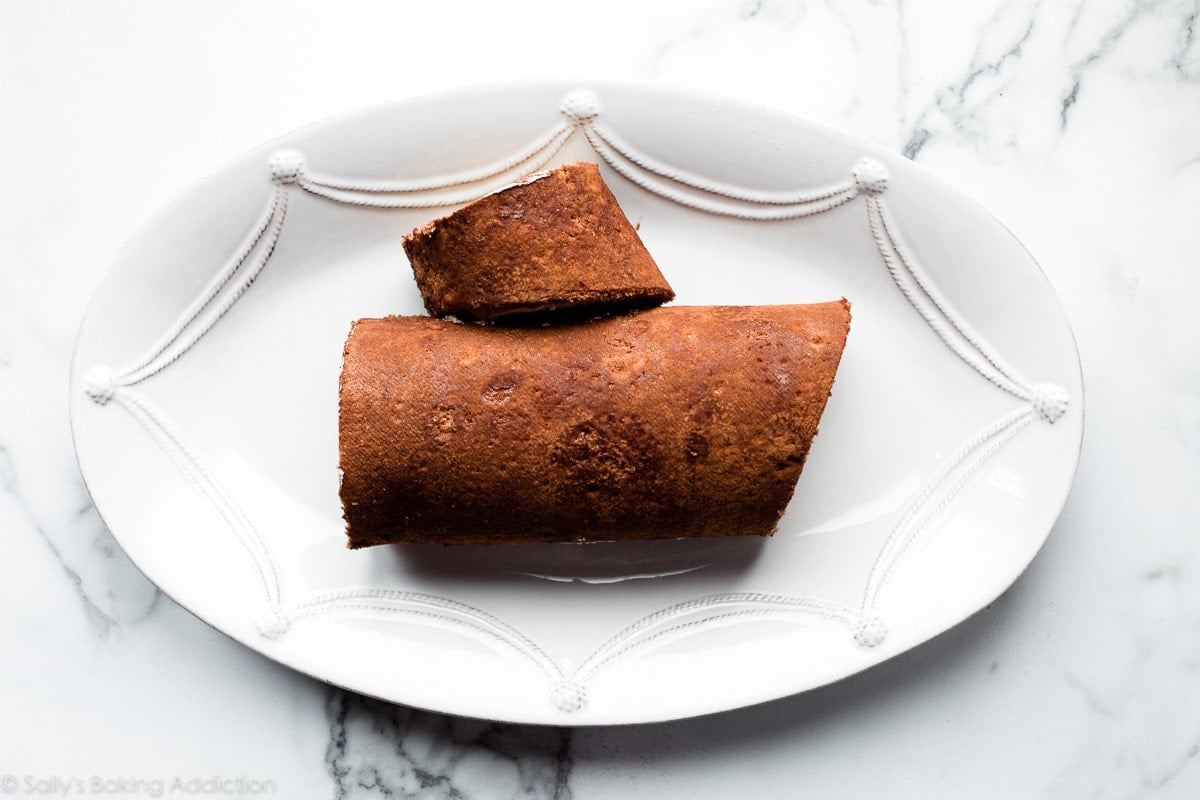 shaped yule log on white serving platter