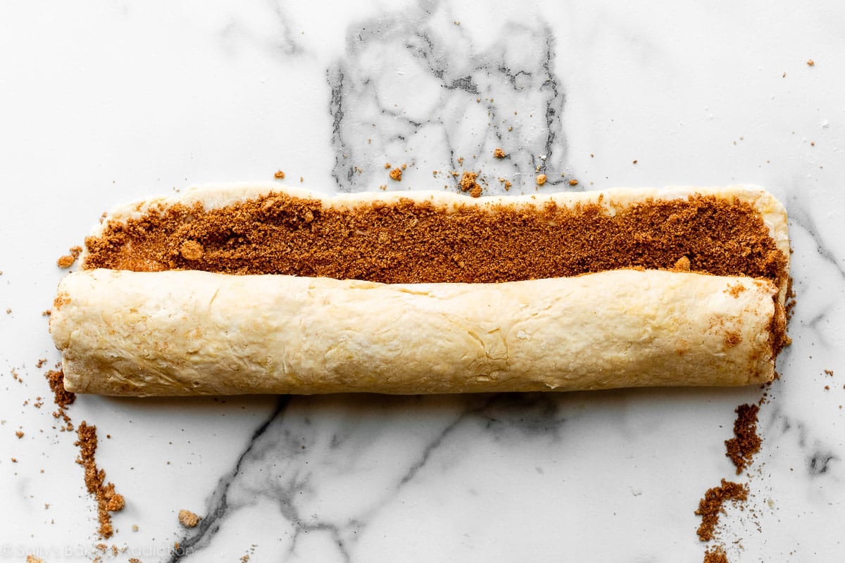 dough rolled up into log filled with cinnamon and brown sugar.