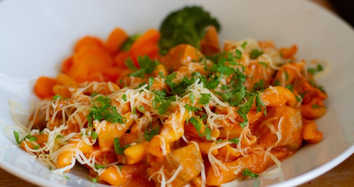 Close up of Capricci pasta with diced pork and tomato and mascarpone sauce