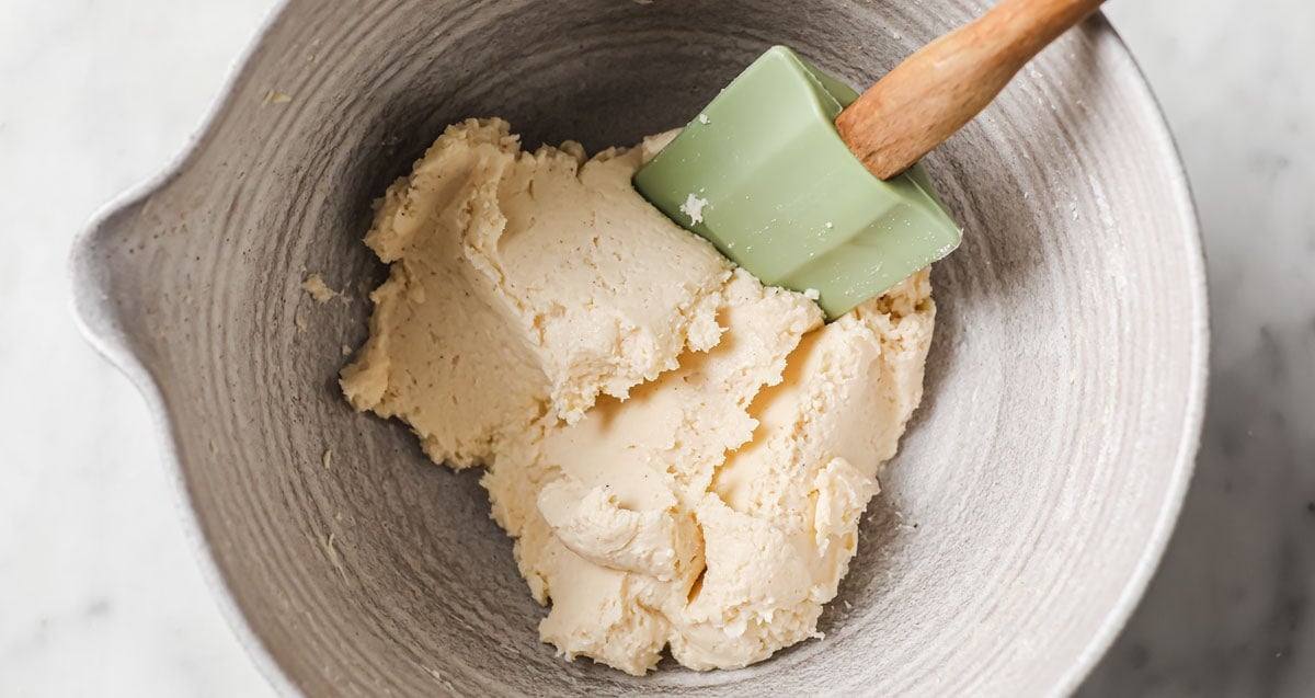 ricotta gnocchi dough in a bowl with a spatula