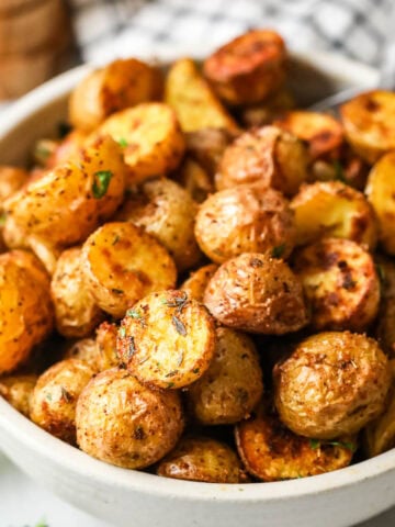 Bowl of crispy and golden brown oven roasted potatoes.