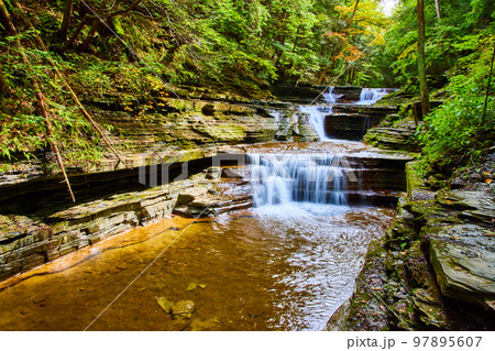 Beautiful tiers of waterfalls in rocky gorge and forest of Upstate New York 97895607