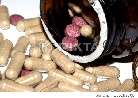 Vitamin Capsules and Pills on a White Background For Medication in a Bottle 119298309