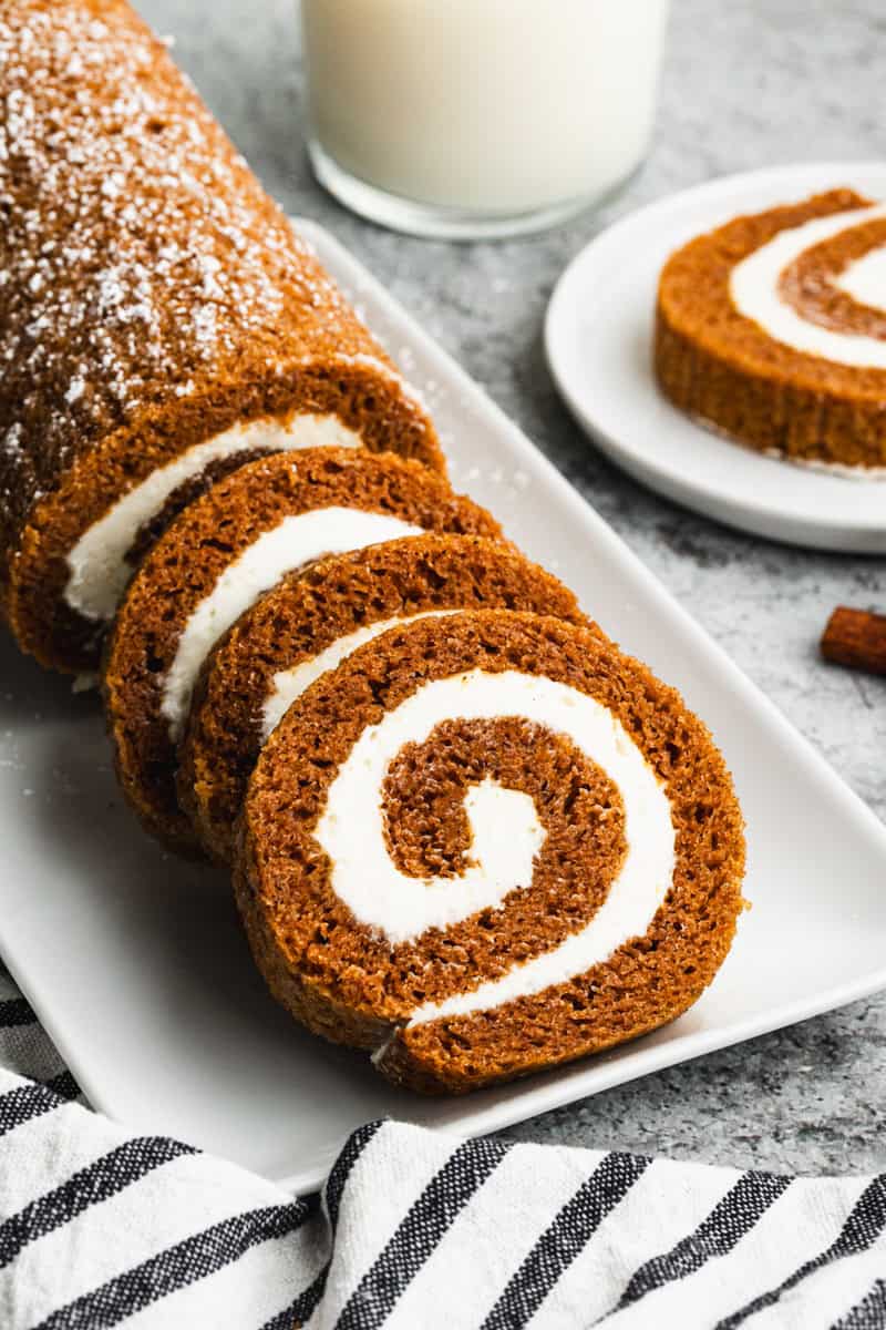 An easy Pumpkin Roll recipe with three slices cut to show the perfect spiral. 