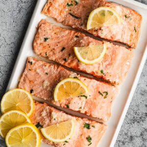 An easy baked salmon recipe on a platter, cut into four fillets and ready to serve.