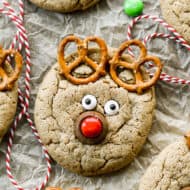 A peanut butter cookie with pretzels, candy eyes, a rolo, and a red m&m to make it look like a reindeer face.