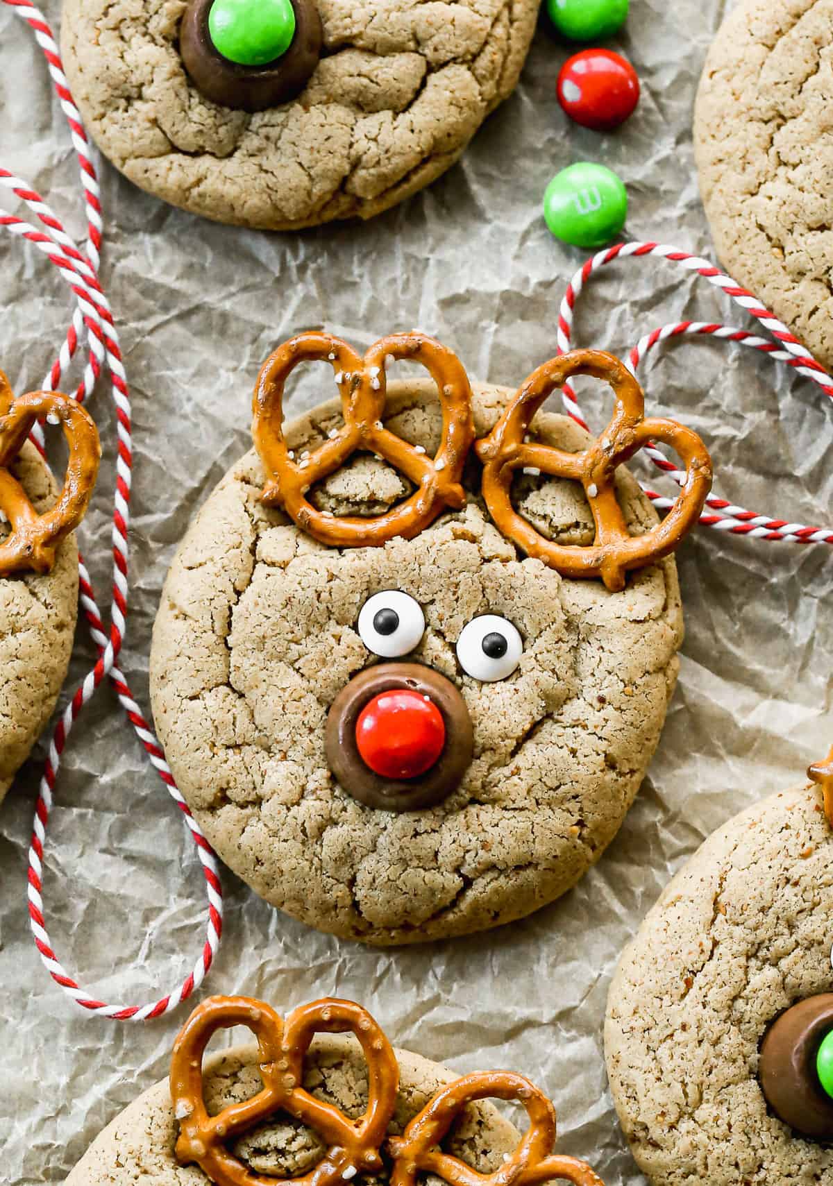 A peanut butter cookie with pretzels, candy eyes, a rolo, and a red m&m to make it look like a reindeer face.