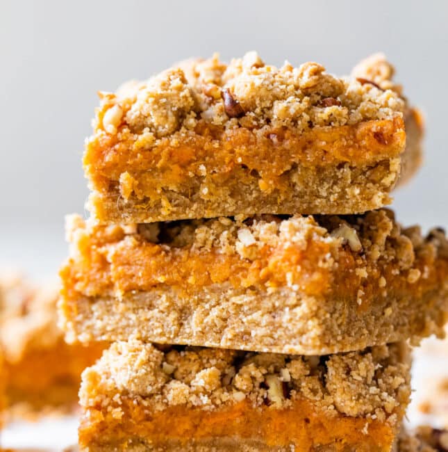 a stack of three bars with sweet potatoes and a crumb topping