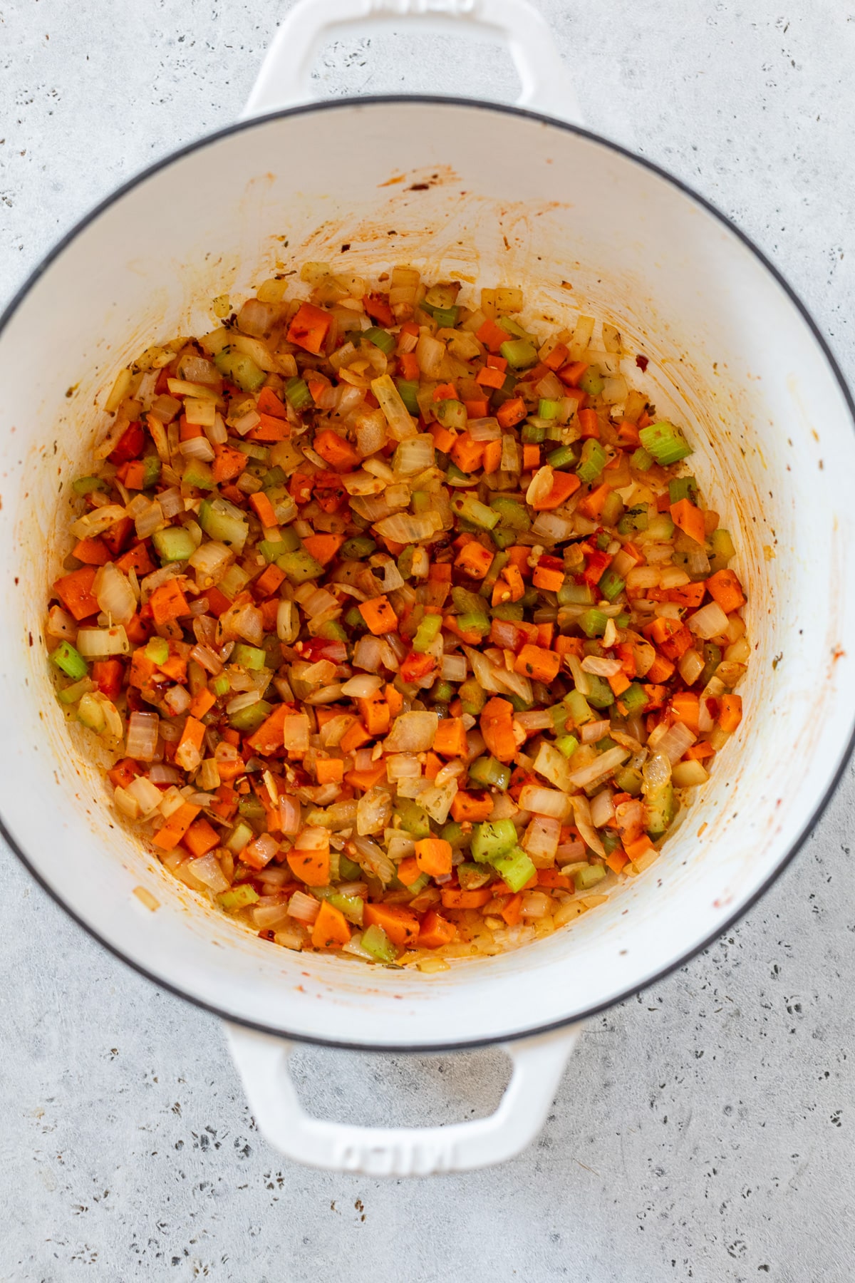 sauteed vegetables in a white dutch oven