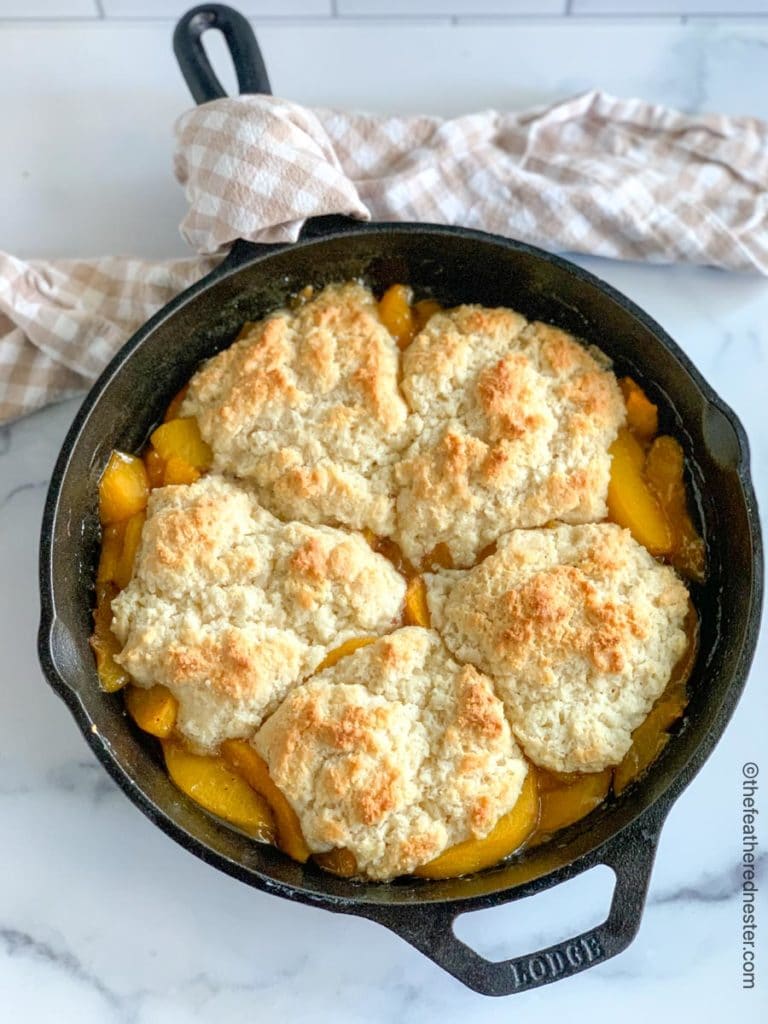 a cast iron skillet with peach cobbler.