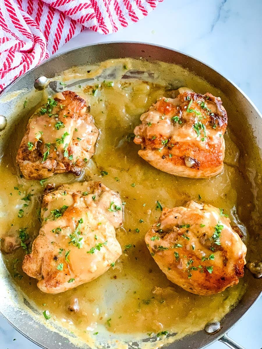 a stainless steel skillet of pan seared chicken.