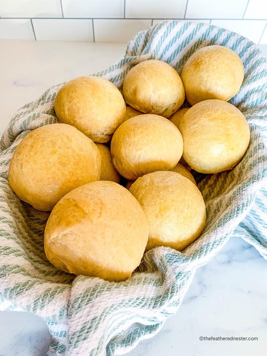 sourdough rolls on a striped kitchen towel.