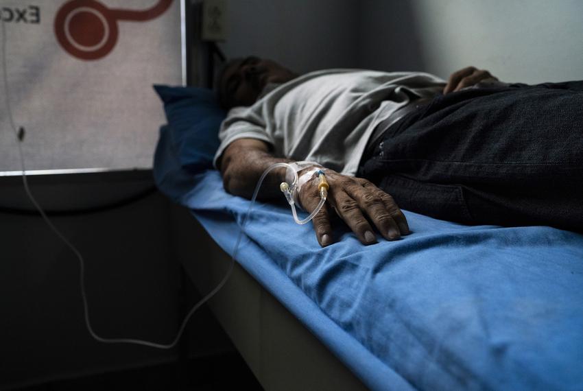 José, Carlos' father, is admitted into a private clinic after health complications. He says he does not work because he falls ill very frequently when he does and earning less than $10 dollars is not enough to afford his medication.