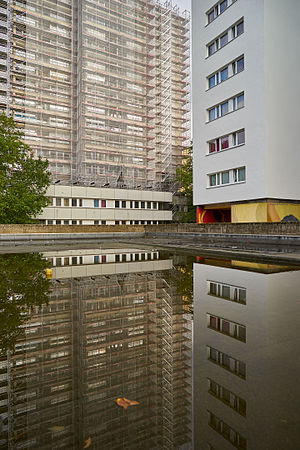 Tower building at Friedrichstraße and its reflection in a puddle. North of Mehringplatz, Berlin-Kreuzberg.