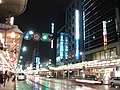 Electric lights illuminate street at night