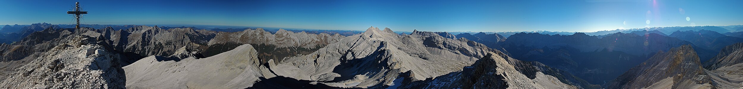 Gipfelgruppe in der Hinterautal-Vomper-Kette mit Birkkarspitze und südlichen Nebengipfeln (+ Birkköpfe) von der Großen Seekarspitze mit Blickrichtung Osten zur ebenfalls spitzen Kaltwasserkarspitze. In der linken Bildhälfte die Nördliche Karwendelkette jenseits des Karwendeltals und ganz links ein Fernblick zur Zugspitze, rechts Hinterautal und die Bergketten entlang des Inntals. → photo description with annotation frames in photo.