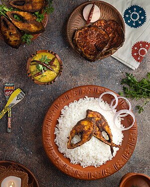 Hilsa fish-rice with dal chachchori and eggplant fry. Fried hilsa, brinjal bhaji and dal chachchori with smoky hot rice is a unique combination of Bengali food habits.