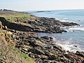 Falaises gardant des traces de leur exploitation par le passé comme carrières de granite entre la Plage Grise et la Crique de Prat Hervet.