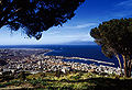 A city center view with the harbour, the Straits and the Etna peak