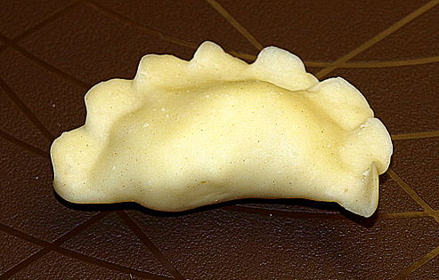 A single uncooked pierogi