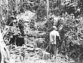 Two U.S. Marines check a Japanese coral block bunker near Point Cruz in November, 1942.