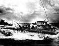 A Water Buffalo, loaded with Marines, churns through the sea bound for beaches of Tinian Island near Guam. July 1944