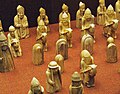 A selection of some the other chess pieces, with a row of Bishops at the back, then a row of Knights.