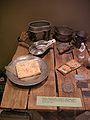 A collection of daily-use utensiles of POWs from various WWII POW camps, mostly Stalag Murnau