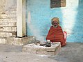 A sadhu warming the morning tea