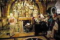 Pilgrims queue to touch rock of Calvary in Chapel of the Crucifixion