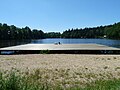 Čeština: Rybník Mrhal na Rudolfově, okres České Budějovice, je oblíbeným místem pro koupání. Vznikl na místě bývalého lomu. English: Mrhal pond in Rudolfov, České Budějovice district, Czech Republic, is a popular place to go swimming. It used to be a quarry.