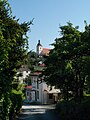 Čeština: Pohled ulicí Mlýnské údolí na Rudolfově v okrese České Budějovice k moštárně/palírně a kostelu English: View of the distillery and the church in Rudolfov, České Budějovice district, Czech Republic