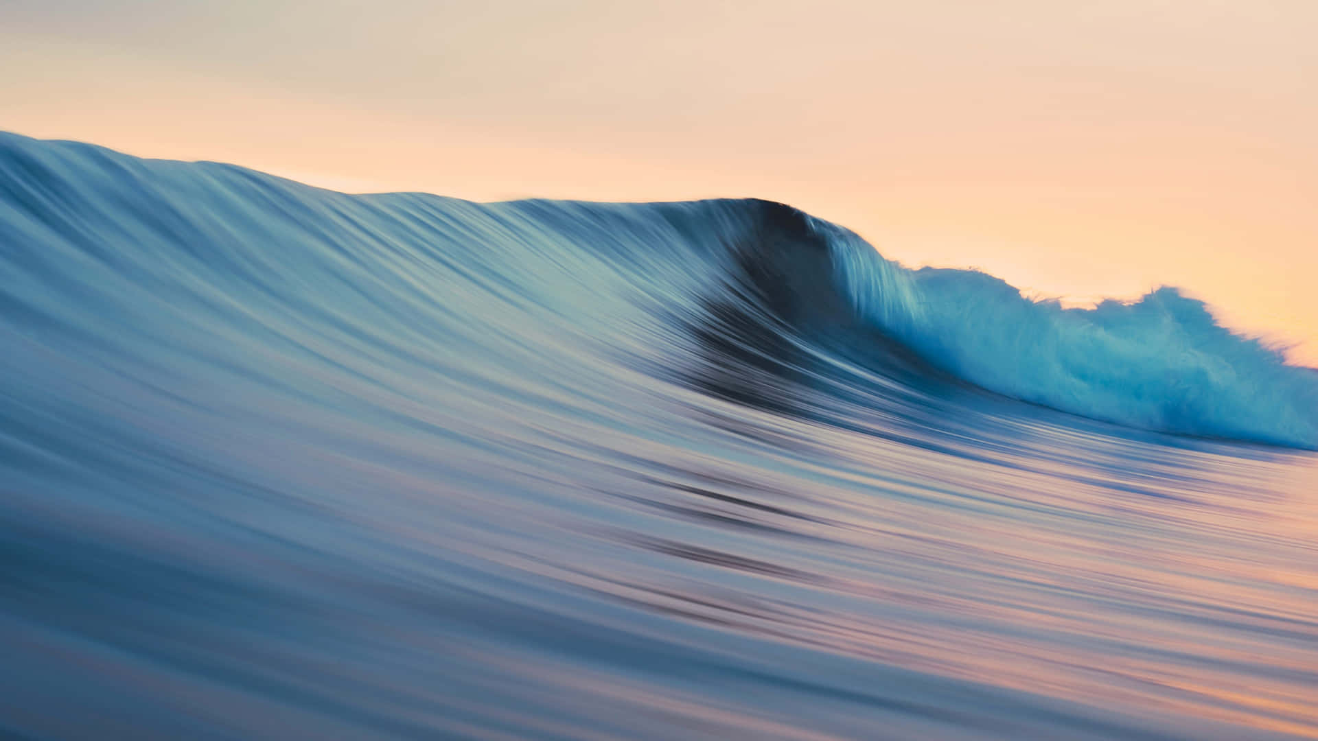 A Wave Is Breaking On The Ocean At Sunset Wallpaper