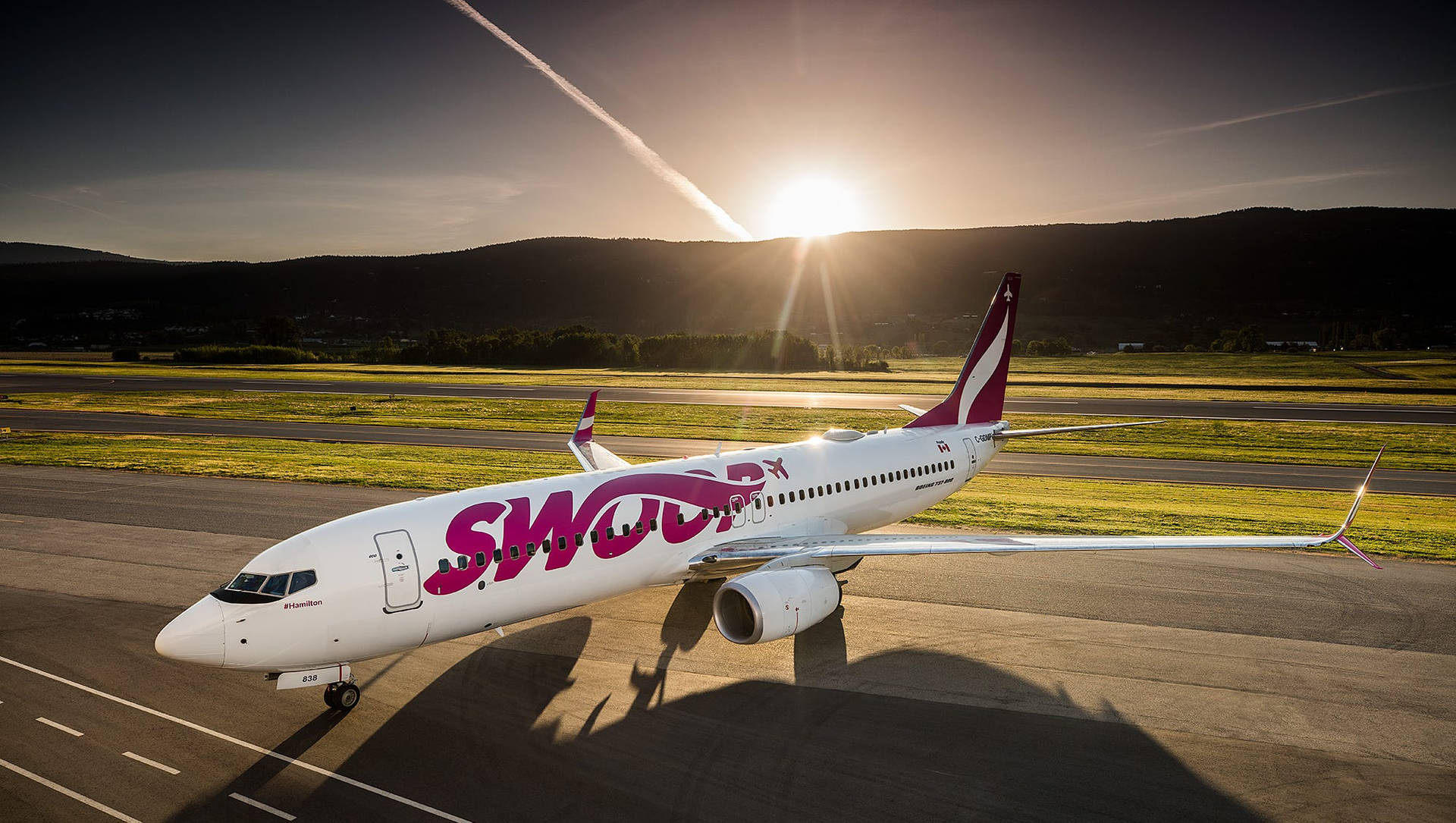 Swoop Airlines Flight At Sunrise Wallpaper