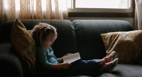 Child reading a book. Picture by Josh Applegate